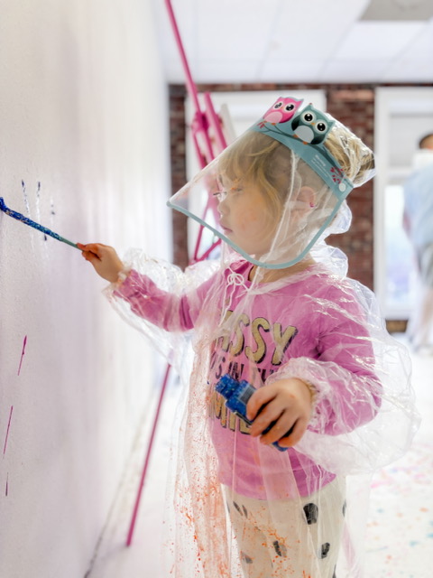 Painting a canvas during splatter session